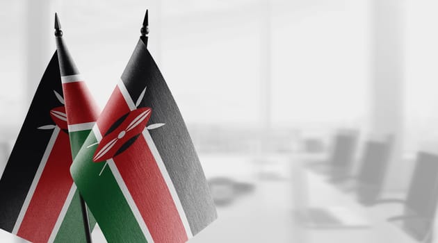 Small flags of the Kenya on an abstract blurry background.