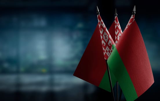 A small Belarus flag on an abstract blurry background.