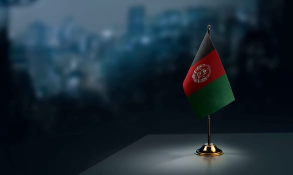 A small Afghanistan flag on an abstract blurry background.