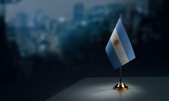 A small Argentina flag on an abstract blurry background.