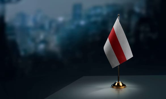 A small Belarus flag on an abstract blurry background.