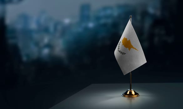 Small flags of the Cyprus on an abstract blurry background.