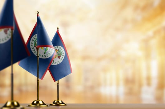 A small Belize flag on an abstract blurry background.