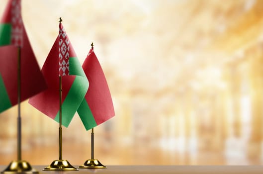 A small Belarus flag on an abstract blurry background.