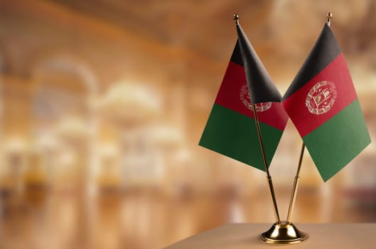 A small Afghanistan flag on an abstract blurry background.