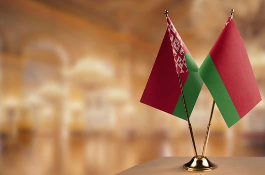 A small Belarus flag on an abstract blurry background.