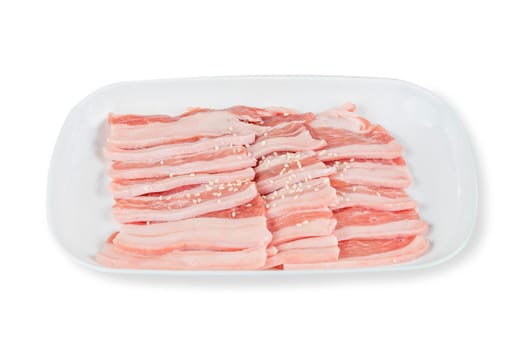 raw pork on plate over white background
