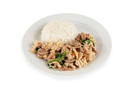 stir-fried pork and squid fried chili pepper and  sweet basil served with steamed  rice on dish over white background