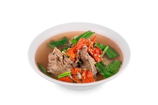 pork bone with chili and vegetables spicy and sour soup  in bowl over white backgrounnd