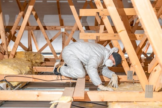 work on the attic of the house, insulated with glass wool. High quality photo