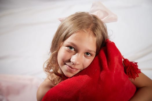 Portrait of cute kid girl posing in pink beautiful dress on white background. Model in studio looking as gentle magic princess from fairy taly having photo shoot on white background