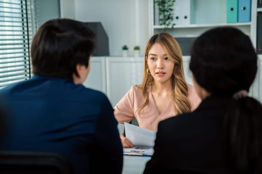 A young female asian candidate tries to impress her interviewer by being competent. International company, multicultural environment in workplace.