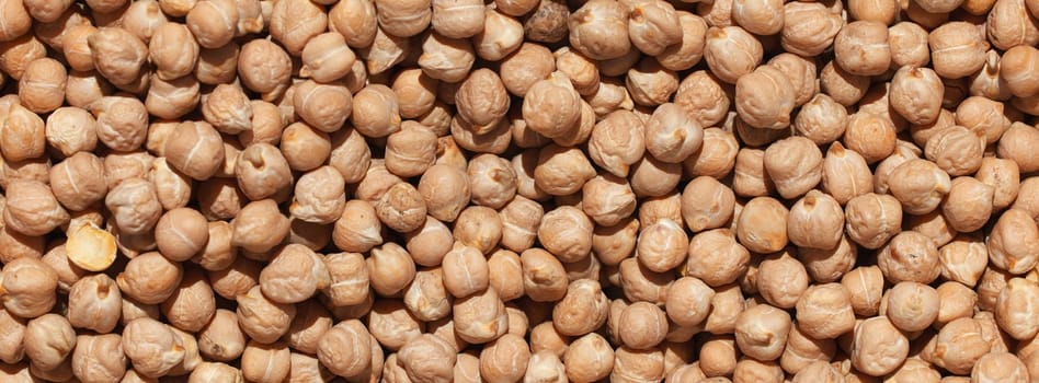 Raw chickpea beans. Top view on chickpea seeds. Food background from a texture of raw chickpeas close-up, top view. Uncooked chickpea. healthy food banner
