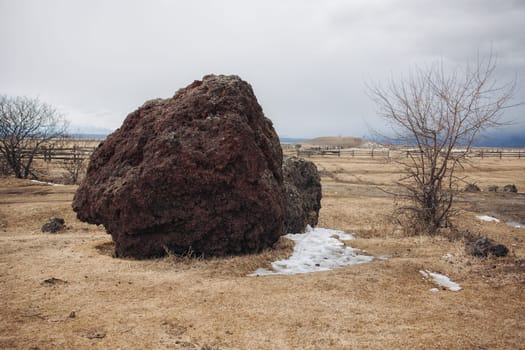 A large volcano penza stone in a deep Buryat village lies motionless waiting for travelers