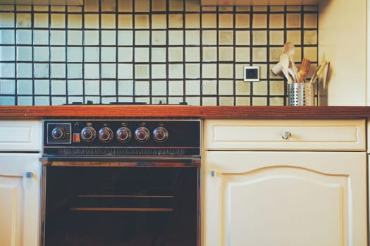 Vintage retro kitchen with green pattern tiles, american retro kitchen home interior design 70's 80's style close-up. retro background