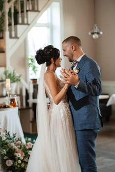 the first dance of the bride and groom inside a restaurant with heavy smoke