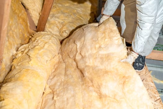 work on the attic of the house, insulated with glass wool. High quality photo