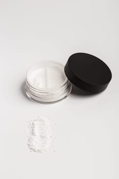 White mineral makeup in container, powder isolated on white