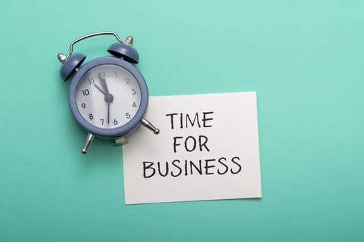 Composition with text Time for Business with blue alarm on azure background upper view. Relationship with business process and self-development