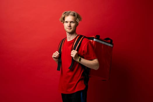 Delivery employee man in red t-shirt thermal backpack work in courier service