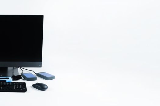 Multiple external hard drives connected to a monoblock on a white background.Computer with hard drive.