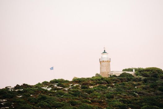 lighthouse and Greek flag on the island of Zakynthos.Greece.