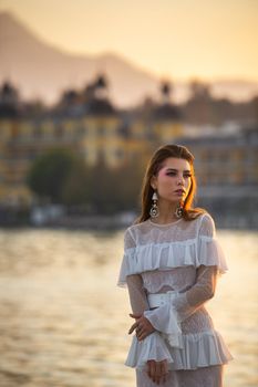 A bride in a white wedding dress in the old town of Austria at sunset.