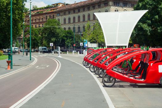 View of 3-wheel bicycle with electric pedal assistance in the parking, Milan