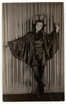 THE CZECHOSLOVAK REPUBLIC, CIRCA 1930s: Vintage portrait photo shows young girl in a retro carnival costum (devil costum). Photo studio portrait, circa 1930s.