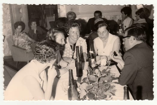 THE CZECHOSLOVAK SOCIALIST REPUBLIC, 1960: Retro photo shows a group of people in a restaurant, 1960s.