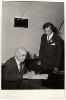 THE CZECHOSLOVAK SOCIALIST REPUBLIC, CIRCA 1970: A vintage photo shows grandfather to signature wedding documents, circa 1970.