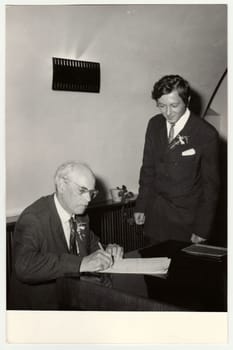 THE CZECHOSLOVAK SOCIALIST REPUBLIC, CIRCA 1970: A vintage photo shows grandfather to signature wedding documents, circa 1970.