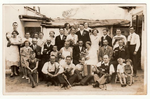THE CZECHOSLOVAK REPUBLIC, CIRCA 1920: A vintage photo shows people in the back yard (during rural wedding feast), circa 1920.