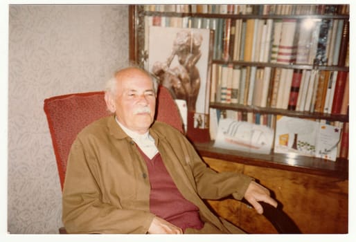 THE CZECHOSLOVAK SOCIALIST REPUBLIC - CIRCA 1980s: Vintage photo shows man sits on armchair, circa 1980s.