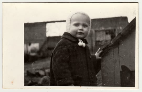 THE CZECHOSLOVAK REPUBLIC, CIRCA 1942: Vintage photo shows a small girl and kannel (doghouse), circa 1942.