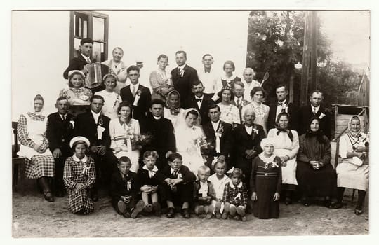 THE CZECHOSLOVAK REPUBLIC, CIRCA 1920: A vintage photo shows people in the back yard (during rural wedding feast), circa 1920.