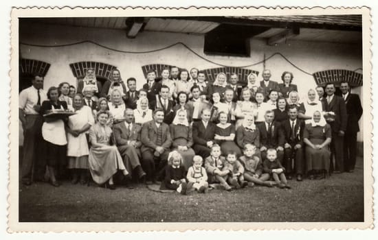 THE CZECHOSLOVAK SOCIALIST REPUBLIC, CIRCA 1960: A vintage photo shows people in the back yard (during rural feast), circa 1960.