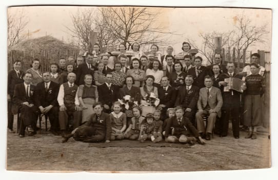 THE CZECHOSLOVAK SOCIALIST REPUBLIC, CIRCA 1950s: A vintage photo shows people in the back yard (during rural wedding feast), circa 1950s.