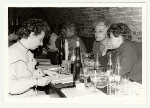 THE CZECHOSLOVAK SOCIALIST REPUBLIC, 1985: Vintage photo shows a group of people in a wine bar.