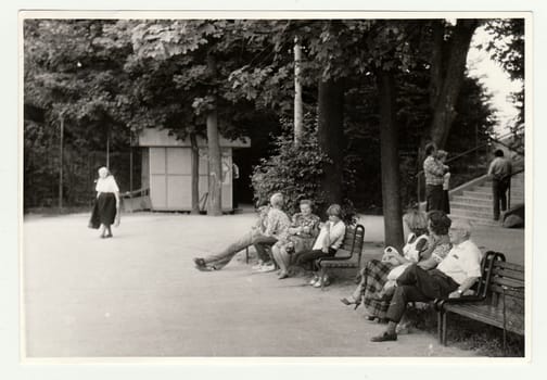 THE CZECHOSLOVAK SOCIALIST REPUBLIC, CIRCA 1981: Vintage photo shows people sit on benches in the city park.