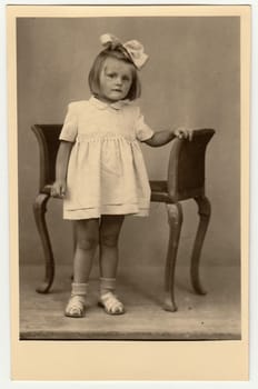 THE CZECHOSLOVAK REPUBLIC - CIRCA 1940s: Vintage photo shows a small girl with ribbon on hair.