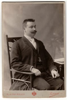 TEPLICE, THE CZECHOSLOVAK REPUBLIC - CIRCA 1930s: Vintage photo shows man with moustache sits on a chair