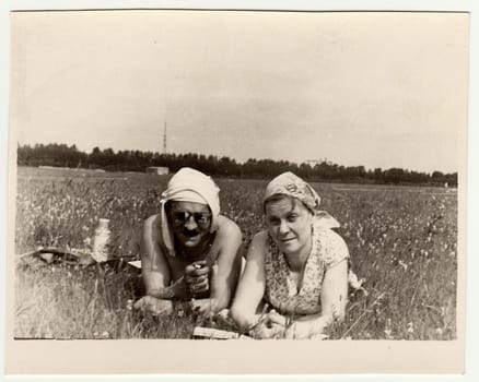 USSR - CIRCA 1970s: Vintage photo shows a marrital couple have a rest on meadow