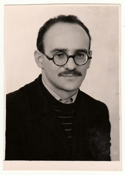 USSR - CIRCA 1960s: Vintage portrait of a young man with glasses and moustache.