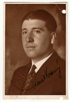 THE CZECHOSLOVAK REPUBLIC - CIRCA 1935: Vintage photo portrait of a man with signature. Photo has origin embossed stamp over the photo.