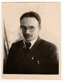 RYBINSK, USSR - CIRCA 1950s: Vintage portrait of a man with glasses