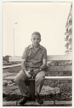 USSR - CIRCA 1980s: Vintage photo shows a mature man sits on a bench.