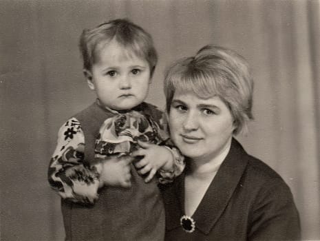 NOVGOROD, USSR - CIRCA 1980: Vintage photo shows mother and child (girl).