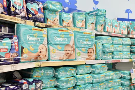 MOSCOW, RUSSIA July 14, 2022: A variety of packages with diapers for children. The Pampers on a store window.