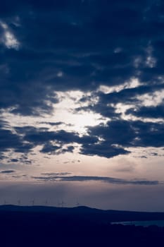 Abstract background sky Dawn Sunset Contrast dark shadow bright cloud sun orange silhouette above the mountains near the sea.